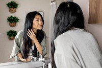 Asian woman haircare in the bathroom