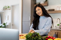 Virtual cooking class through laptop in kitchen