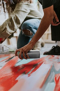 Woman artists collaborating on a painting 