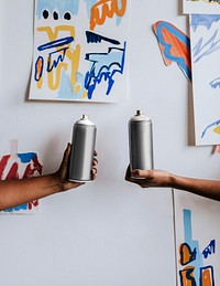 Artsist friends spray paint together 