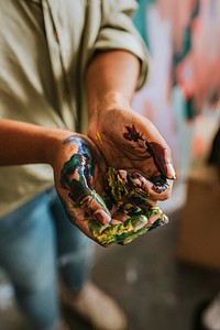 Hands covered in paint 