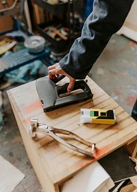 Hand carrying a stapler gun 