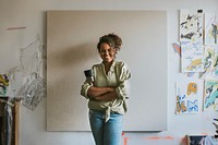 Female artist standing in front of a big blank canvas