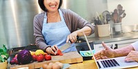 Asian woman cheerfully cooking in the kitchen
