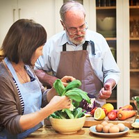 Interracial senior couple in a kitchen cooking healthy food together