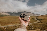 Photographer with analog film camera in nature