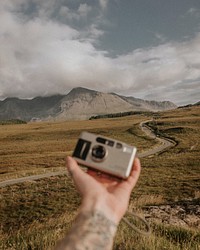 Photographer with analog film camera in nature