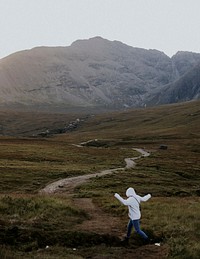 Traveler in the Scottish Highlands, beautiful rugged nature 