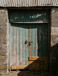 Weathered green stable door at a farm