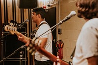 Rock band guitarist performing repetition in recording studio