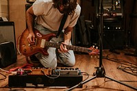 Rock band guitarist performing repetition in recording studio