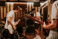 Music band guitarist performing repetition in recording studio