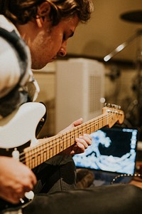 Musician playing electric guitar, aesthetic photography