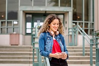 Girl with headphones, checking phone