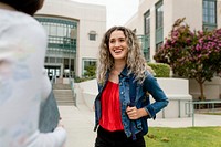 Happy students greeting each other at school