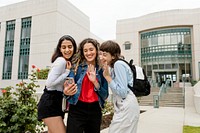 College girls video calling with friends at campus