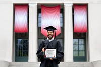 Graduating student holding academic certificate
