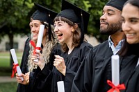 Happy diverse students graduating university, celebrating with diplomas