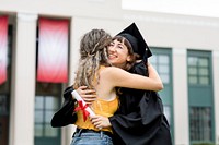 Friends hugging at graduation ceremony 