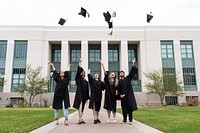 Graduating students throwing graduation caps in the air