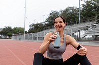 Happy woman athlete drinking water and rest 