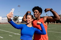 Male and female athletes flexing and taking a selfie