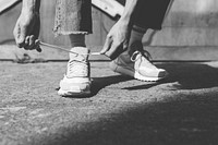 Person tying shoelaces, black and white tone