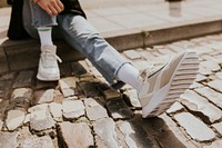 Person sitting on the footpath 