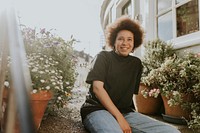 Woman smiling in a home garden, new normal hobby