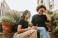 Two friends sitting and talking while having a coffee 