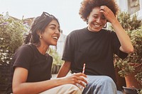 Two friends sitting and talking while having a coffee 