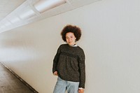 African American woman posing by the wall 