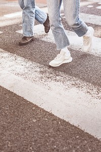 Friends crossing the zebra cross on the road