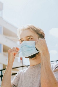 Man putting on a mask in public