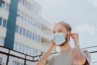 Man putting on a mask in public