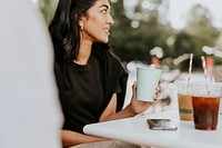 Happy woman carrying a cup of coffee