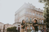 Friends on electric scooters, city sightseeing eco-friendly style