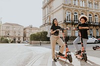 Friends on electric scooters, city sightseeing eco-friendly style