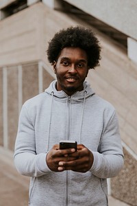 Man in gray hoodie using phone