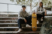 Cool skaters sitting on steps in skate park