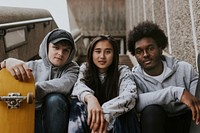 Diverse happy skates sitting on staircase