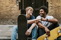 Skaters fist bumping, on sidewalk