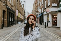 Young woman talking on a phone while in a city