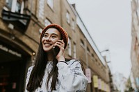 Woman talking on a phone in city