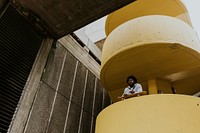 Man with skateboard at yellow stairs