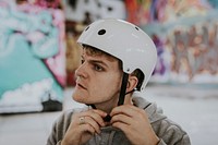 Man wearing white skate helmet for safety