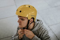 Yellow skate helmet mockup, sports safety equipment, held by man psd