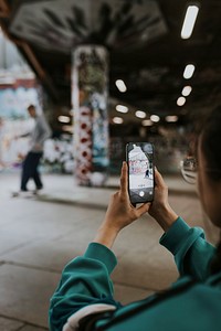 Woman capturing skater at skate park