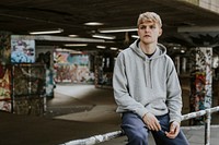 Blond man in gray hoodie at skate park