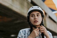 Woman wearing white skate helmet, sports safety equipment